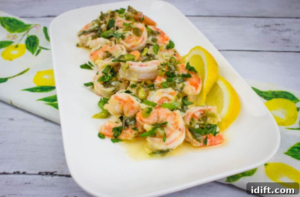 Zesty Garlic Butter Shrimp 8 Shrimp sautéed with fresh herbs and vegetables in a classic garlic shrimp scampi style, elegantly arranged on a rectangular white plate with lemon slices and chopped parsley as garnish.