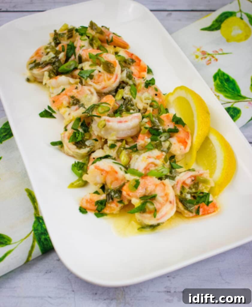 Zesty Garlic Butter Shrimp 3 A beautifully presented Garlic Shrimp Scampi with bright lemon slices on a pristine white platter, ready to serve.
