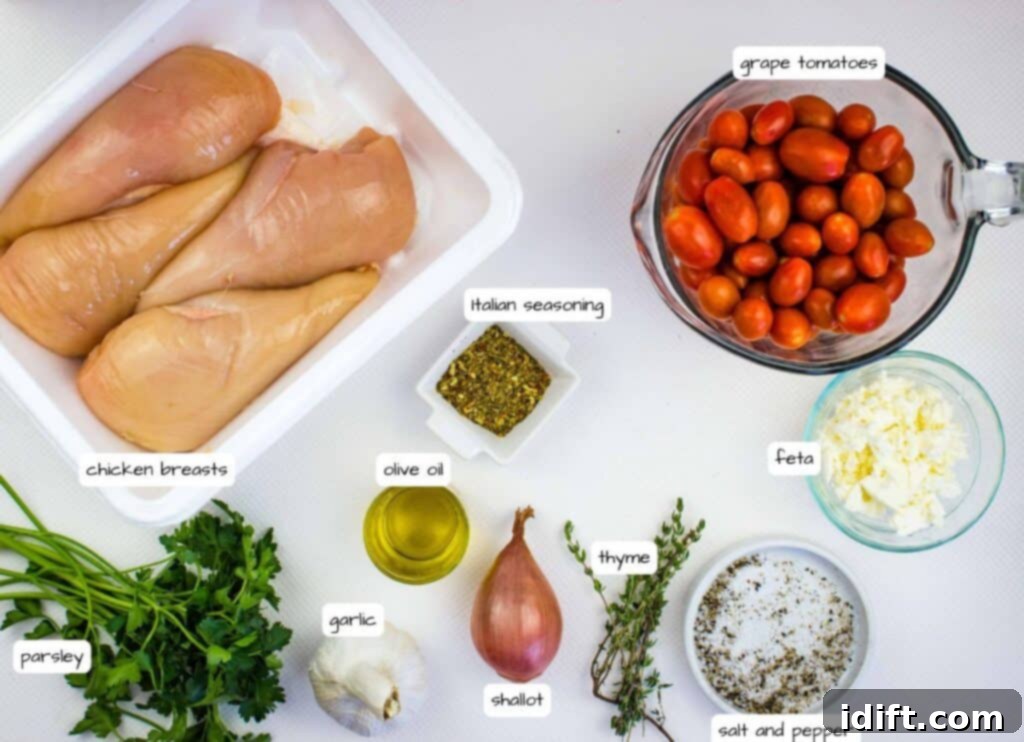 Raw chicken breasts, grape tomatoes, feta cheese, Italian seasoning, olive oil, parsley, garlic, shallot, thyme, salt, and pepper arranged on a white surface, each labeled.