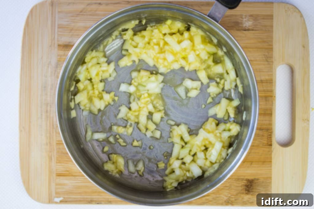 Sauteed onions and garlic mixed with flour in a saucepan