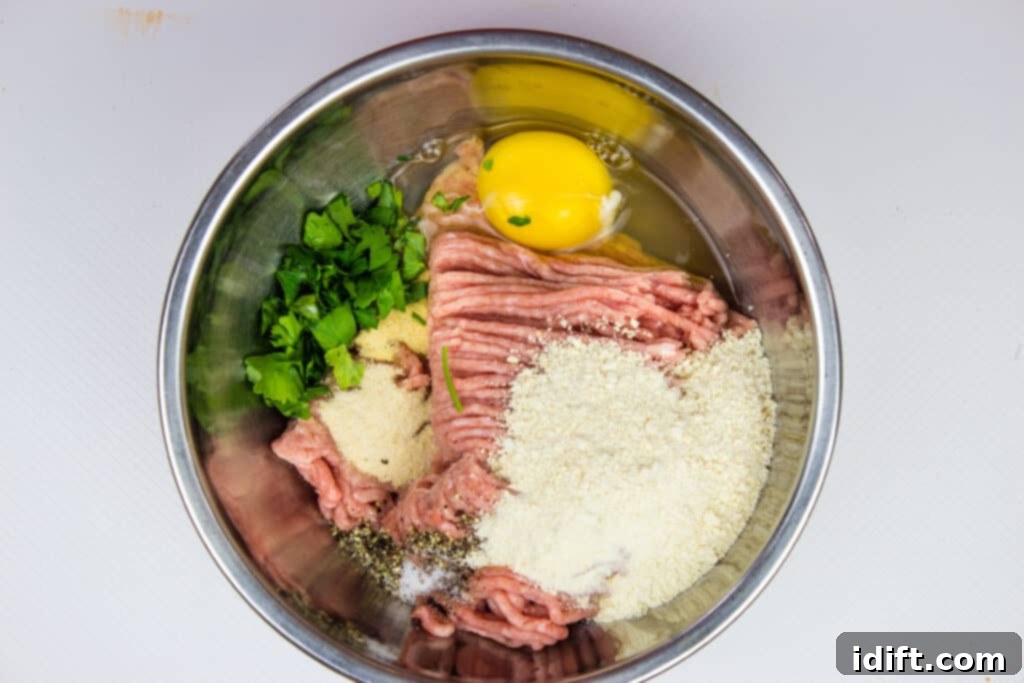 All ingredients for air fryer turkey meatballs placed in a mixing bowl, ready to be combined.