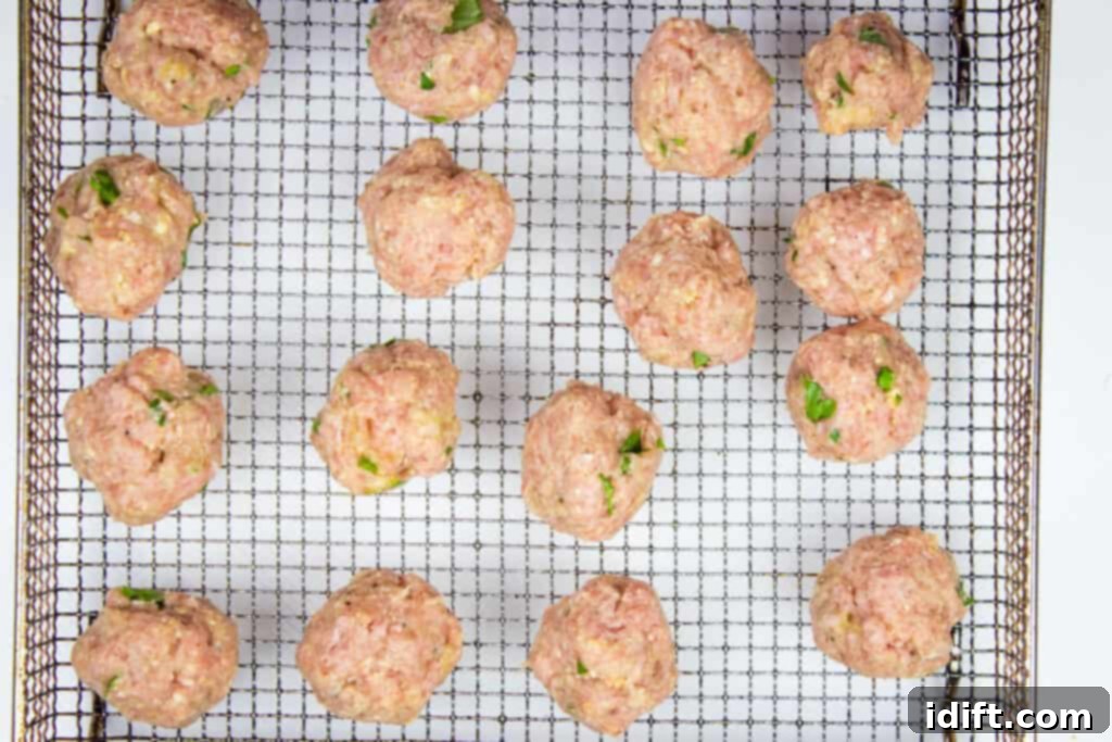 Ping-pong ball sized turkey meatballs formed and ready for cooking.