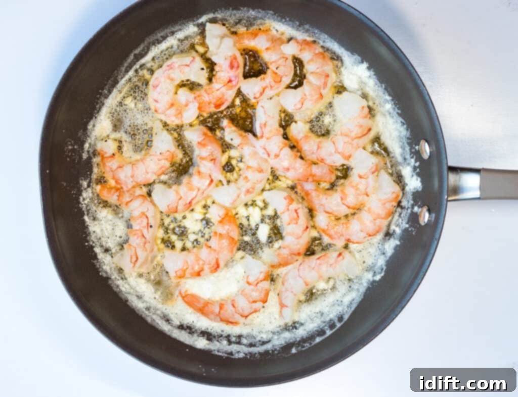 Lemon-Garlic Shrimp Pizza 6 Shrimp cooking in a skillet with garlic butter.