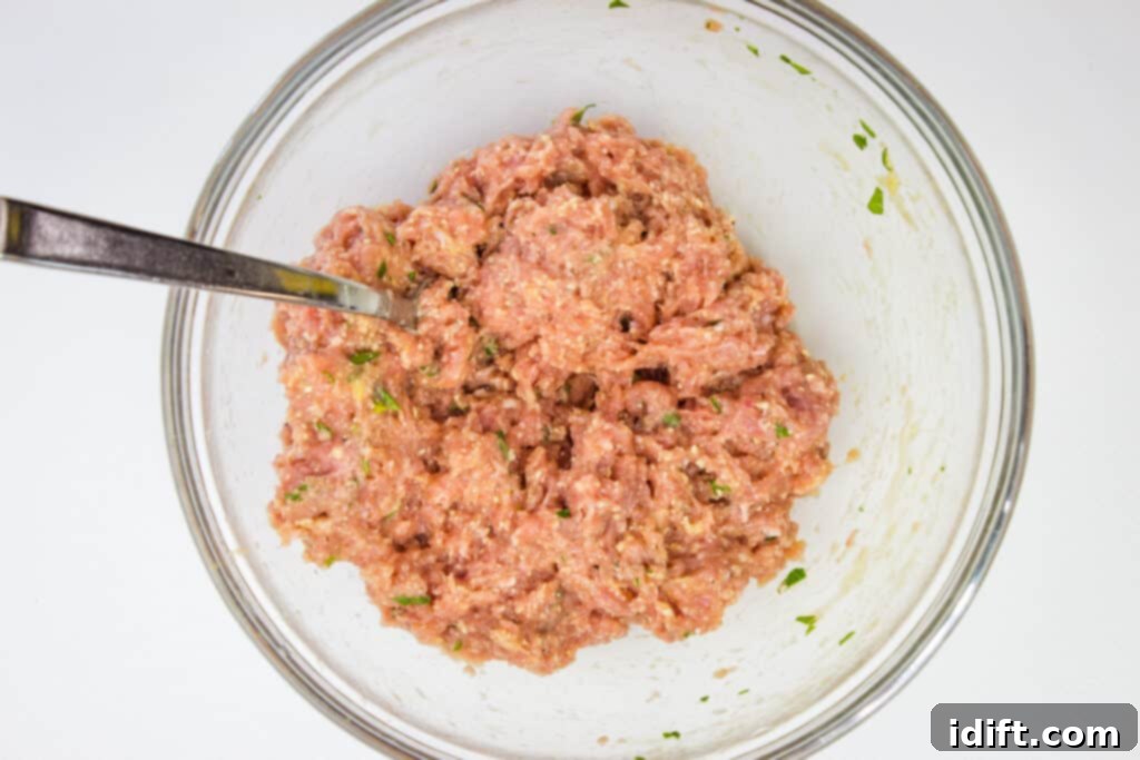 Savory Marsala Chicken Meatballs 8 Meatball mixture in a bowl, showing a light, airy consistency, with a note not to overmix.