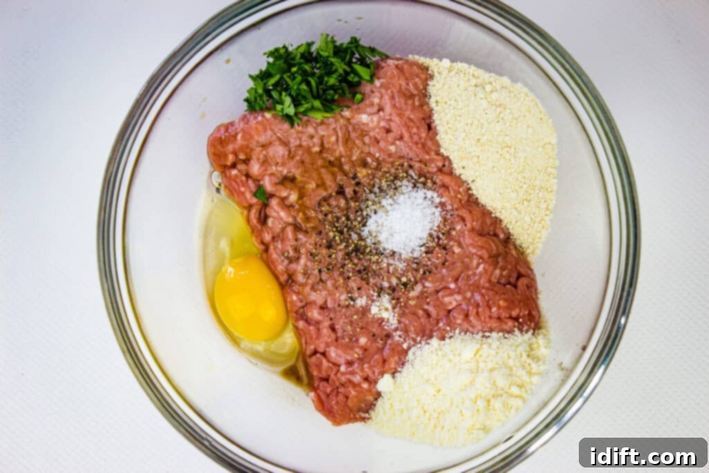 Savory Marsala Chicken Meatballs 7 Mixing bowl with ground chicken and other meatball ingredients being combined.