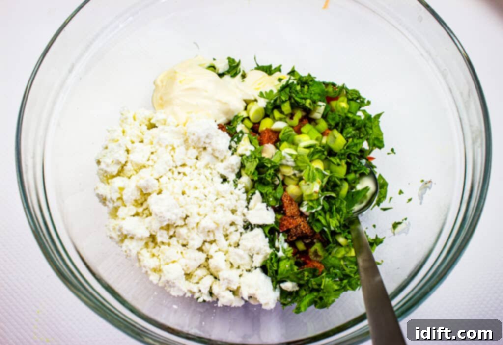 All salad dressing ingredients and half of the cheese mixed together in a large bowl with corn.
