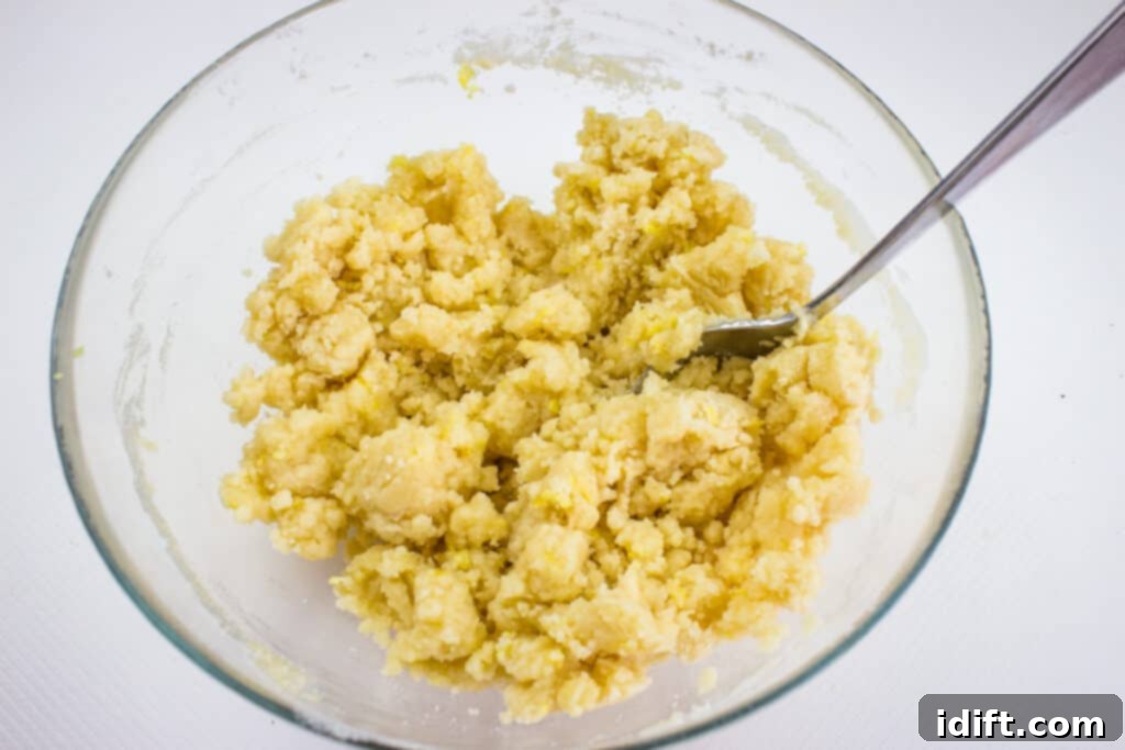 Blissful Strawberry Rhubarb Crumble 6 making the crumble topping by mixing melted butter with dry ingredients