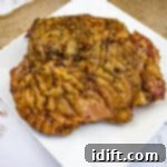 Smoked turkey thigh on a white plate.