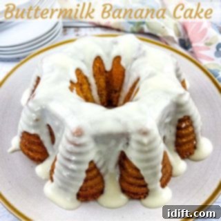 A whole Buttermilk Banana Bundt Cake, golden brown and beautifully shaped, resting on a white plate, inviting a slice.