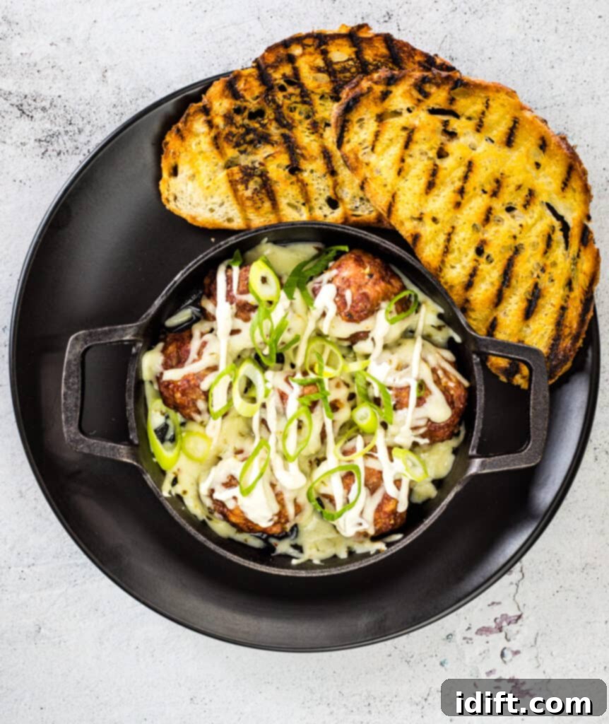 cheese covered smoked meatballs with chipotle sour cream drizzle