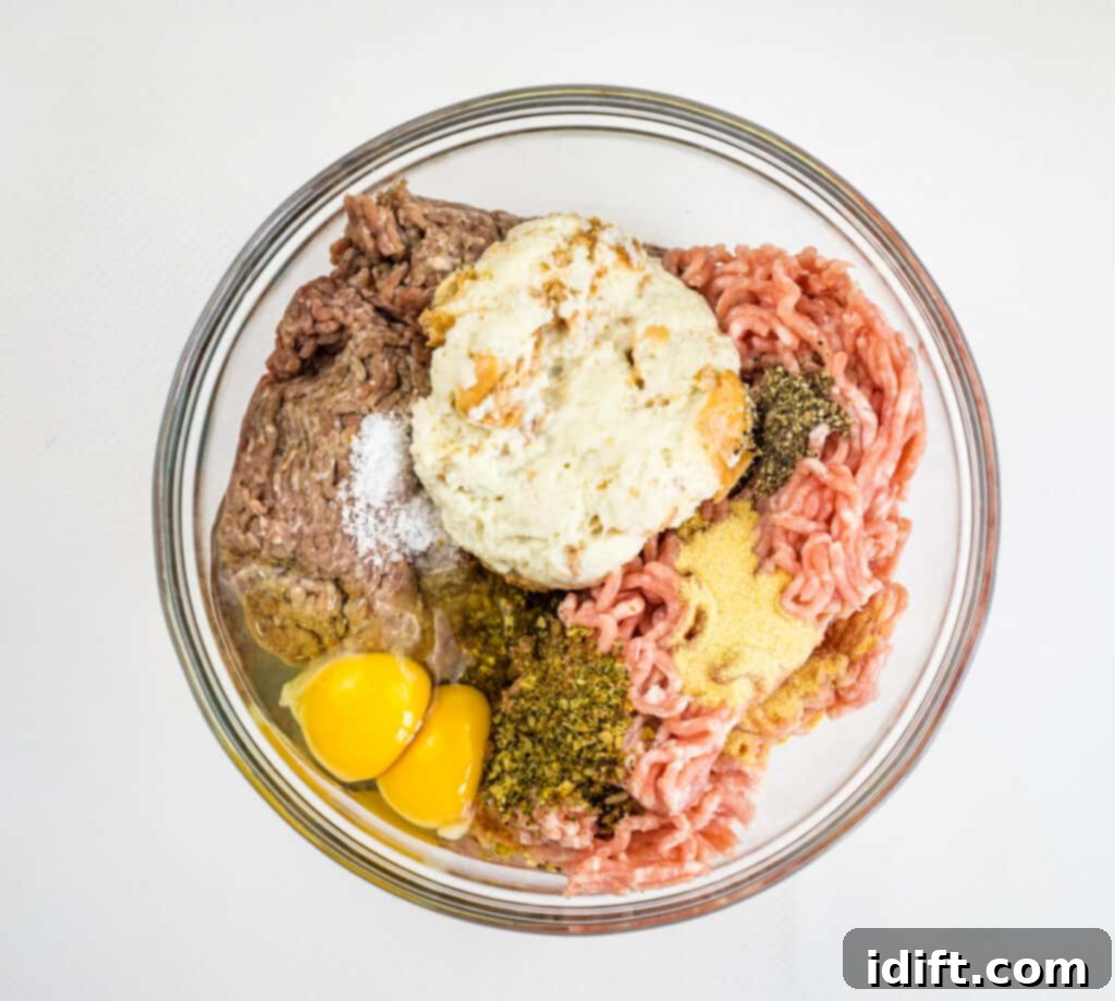 All meatball ingredients combined in a large mixing bowl.