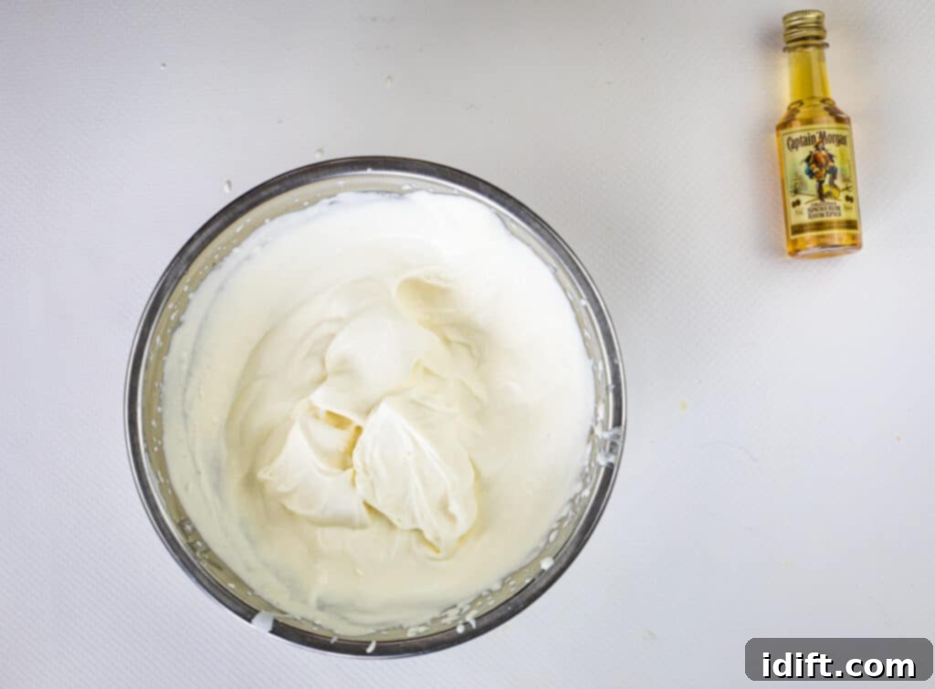 spiced rum whipped cream with stiff peaks in a bowl