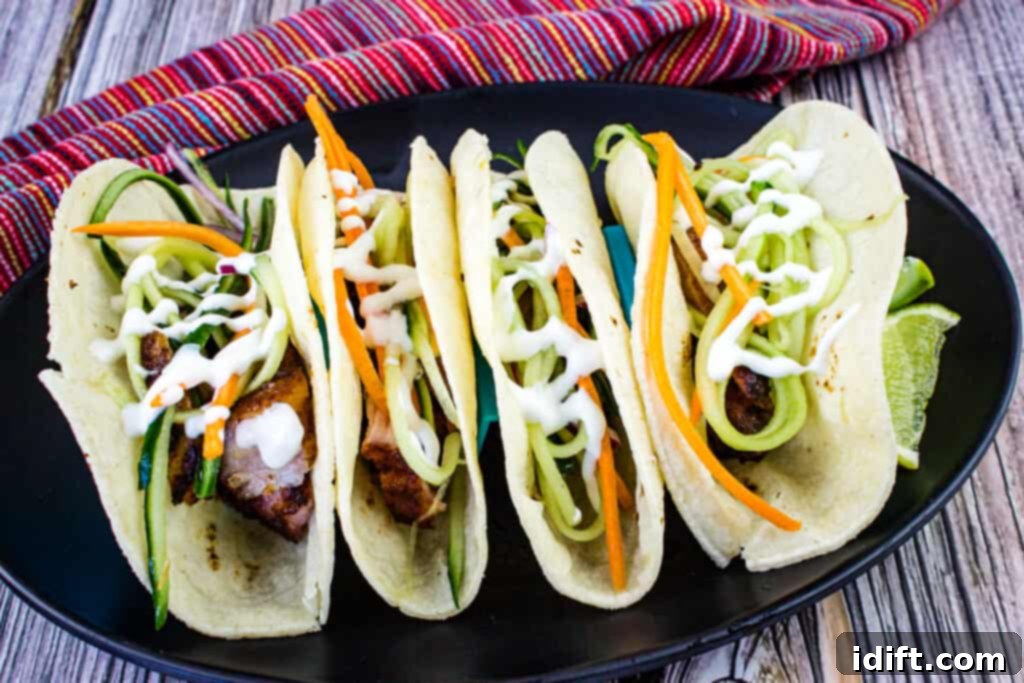 smoked pork belly tacos in a taco holder on a plate