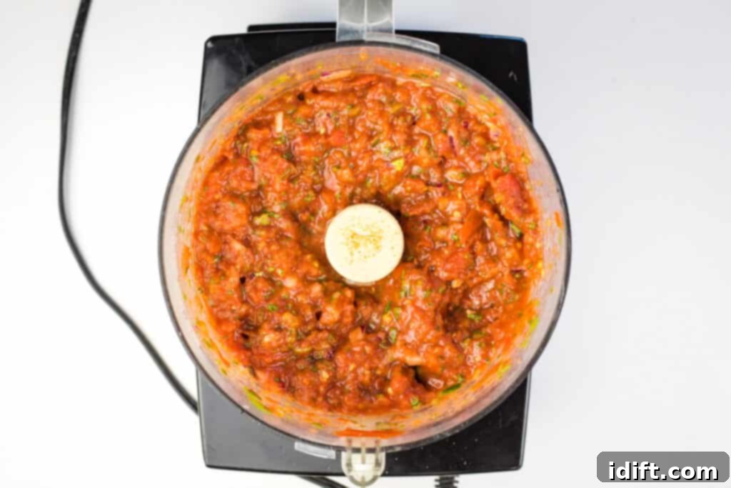 Ember Salsa 7 Pulsing the ingredients for smoked tomato salsa in a food processor