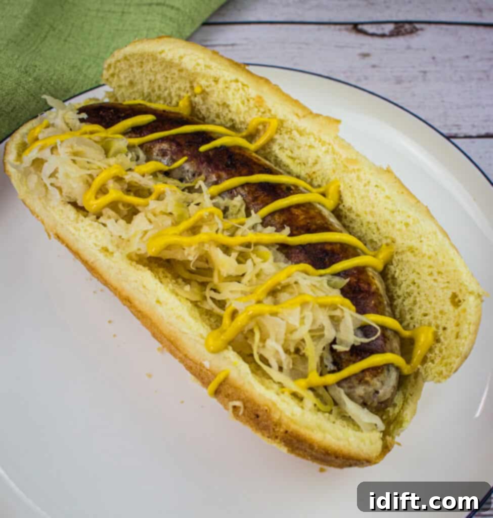 Perfect Sous Vide Sausages 4 sous vide sausage on a bun with toppings