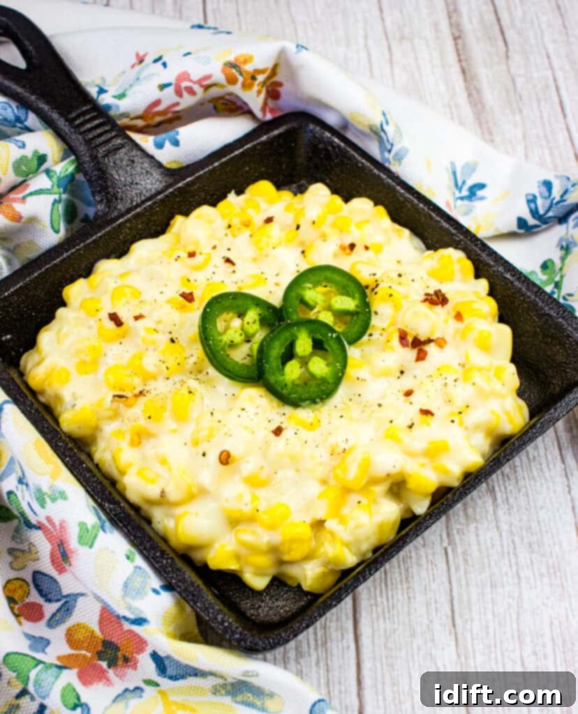 creamed corn in a black serving dish