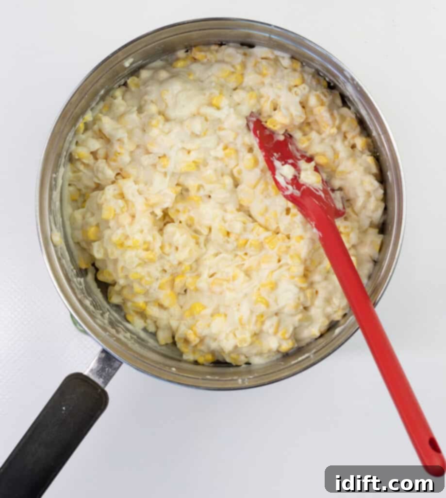 Mixing corn and sauce and heating through