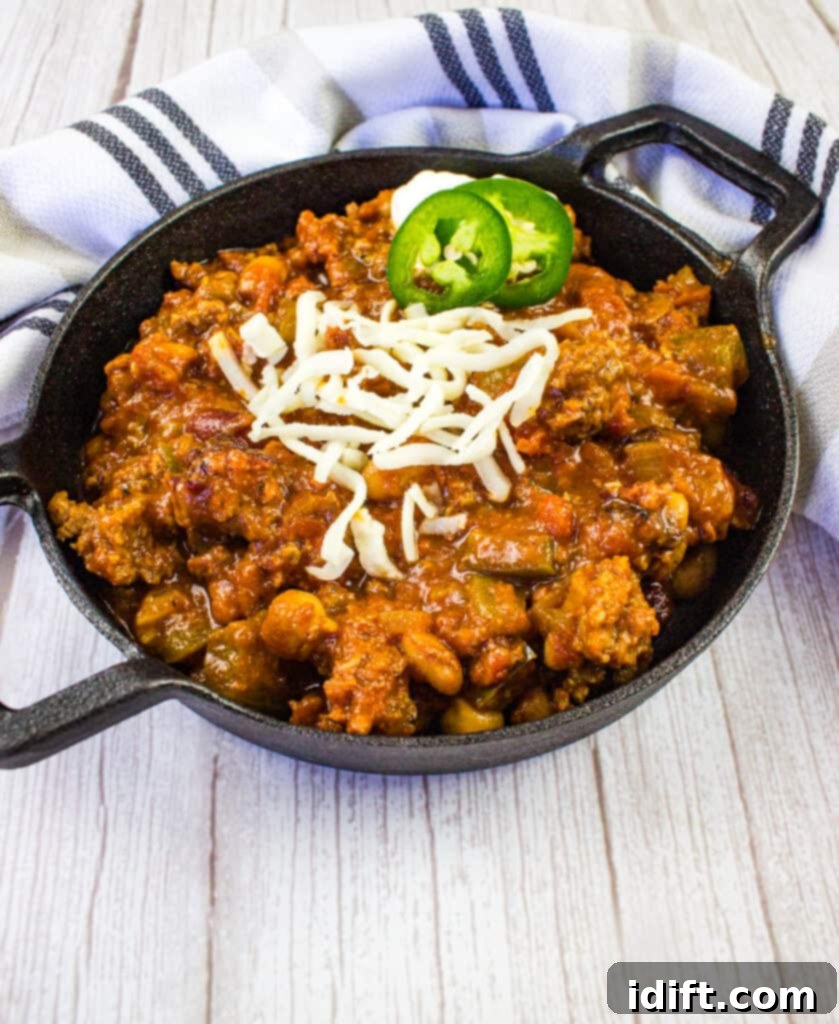 over the top chili in a black serving dish