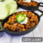 Over the top chili in black cast iron pans