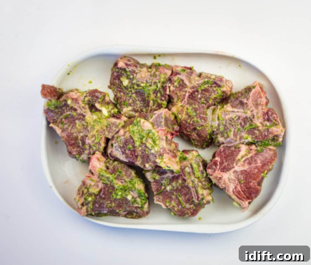 Lamb chops marinating in a mixture of herbs, garlic, and olive oil