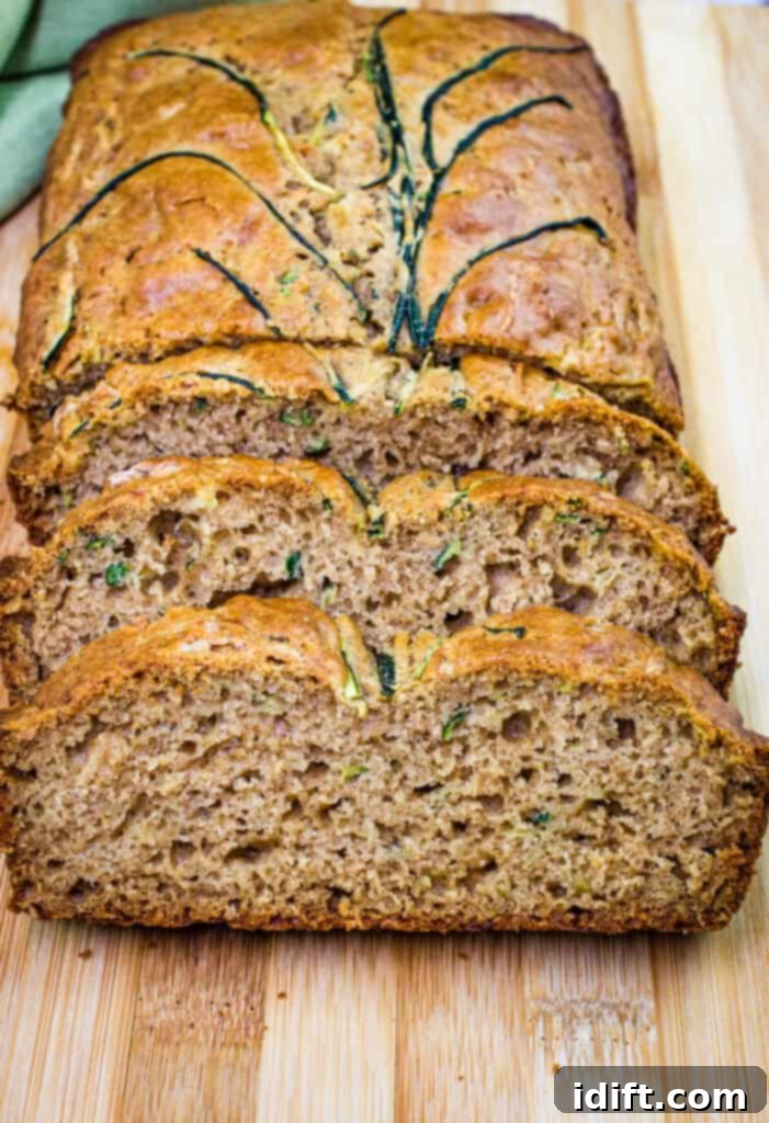 Irresistible Zucchini Bread 2 Sliced zucchini bread on a cutting board, ready to be enjoyed.