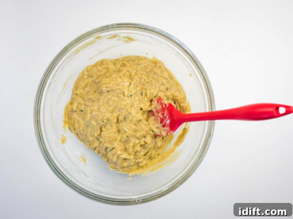 Mixing wet and dry ingredients together to form the batter