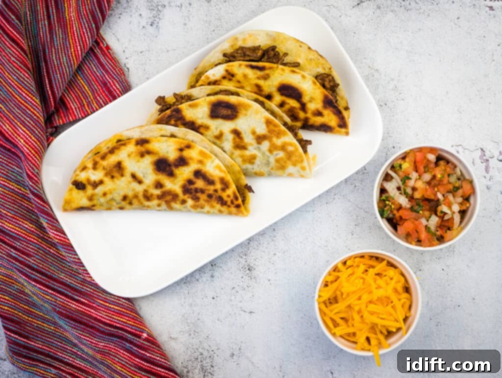 Beautifully arranged Tacos Dorados on a platter with fresh garnishes