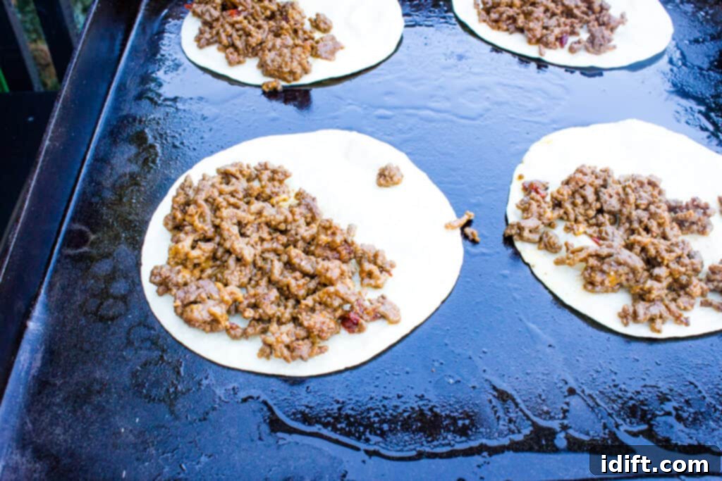 Crispy Tacos Dorados cooking on a hot Blackstone griddle