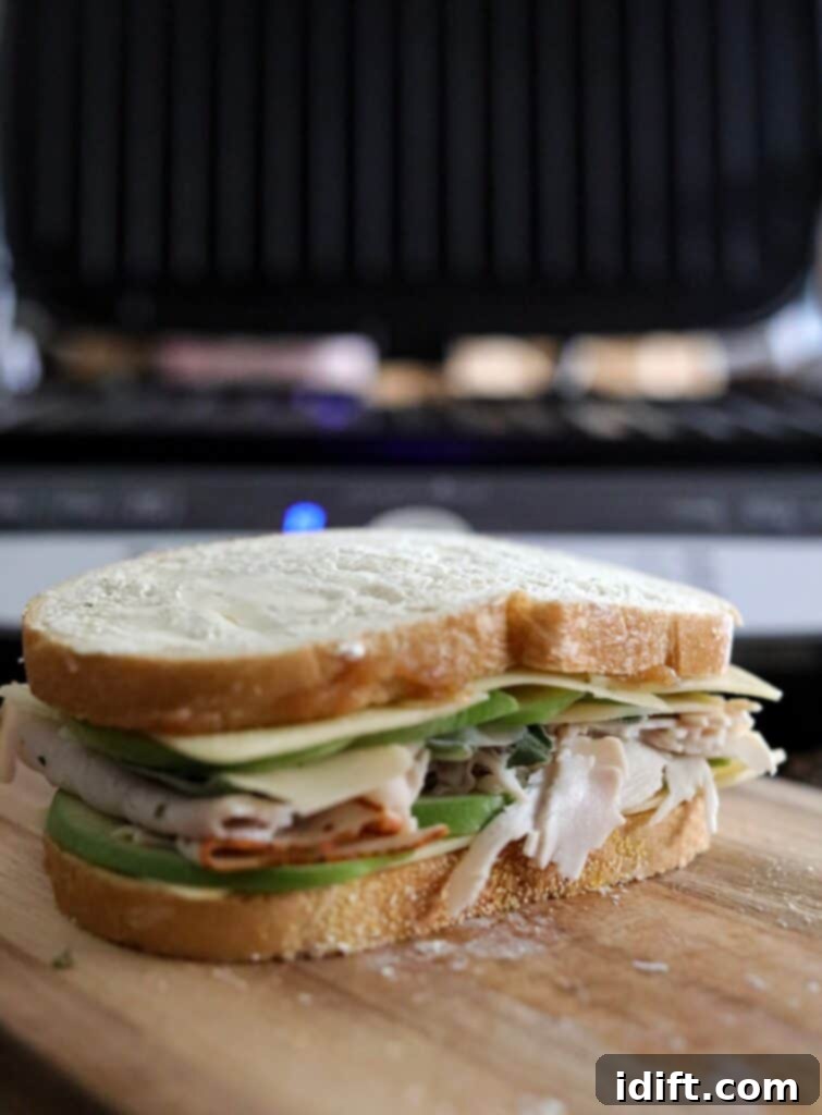 Close the sandwich with the remaining buttered bread, buttered side out.