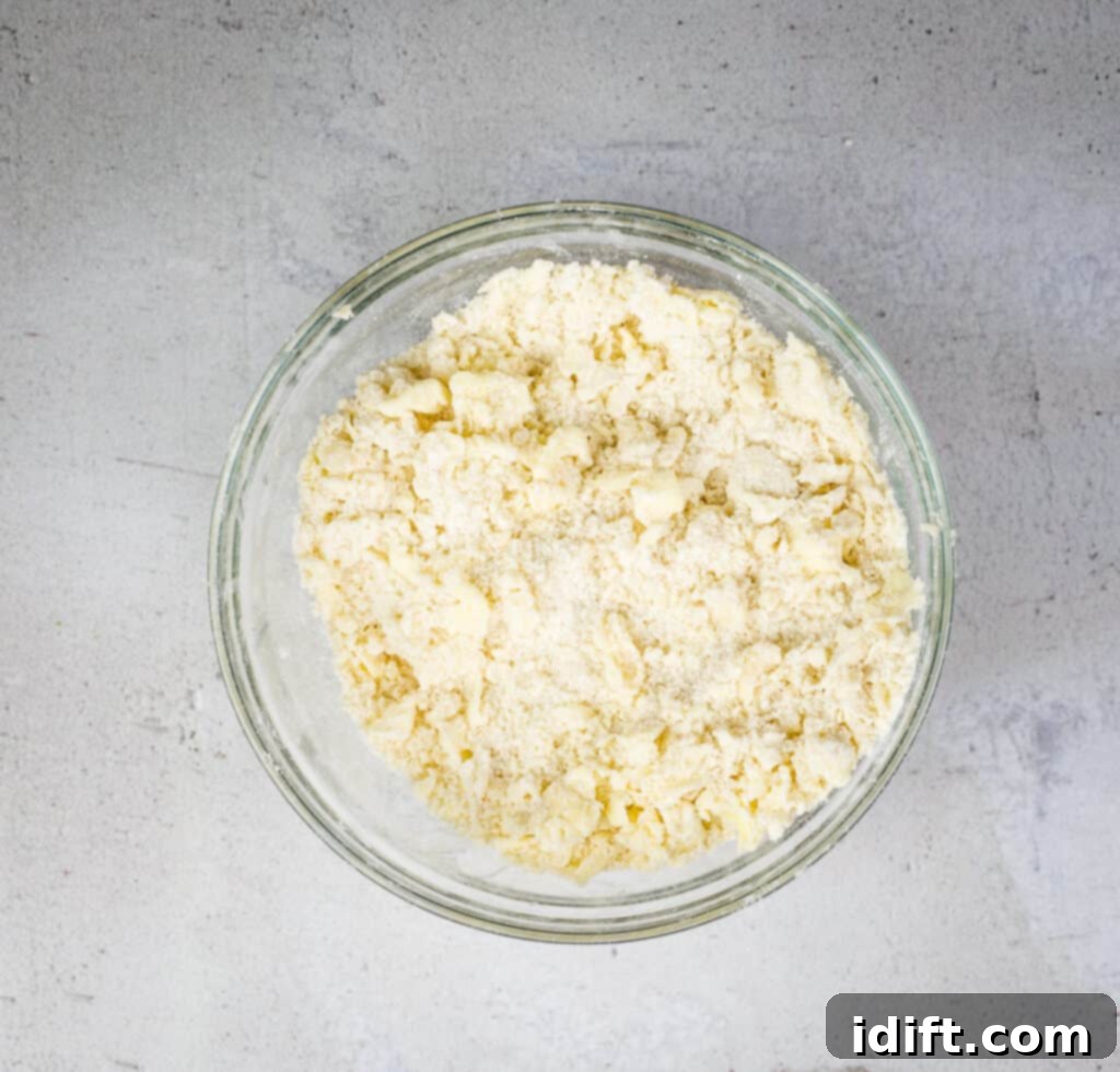 Tangy Cranberry Squares 9 A bowl showing flour, butter, and sugar combined to form the crumbly shortbread crust for the bottom layer.