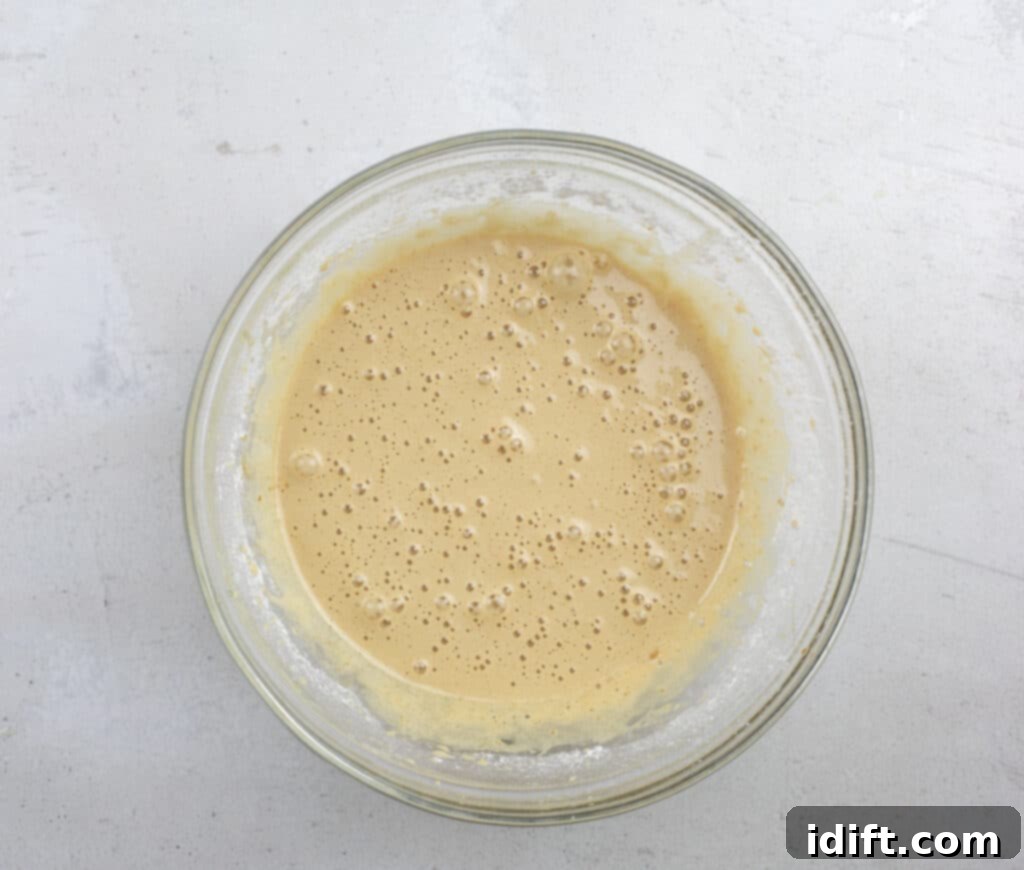 Tangy Cranberry Squares 14 A bowl containing the whipped eggs, brown sugar, vanilla, flour, baking powder, and salt, ready to be blended for the topping.