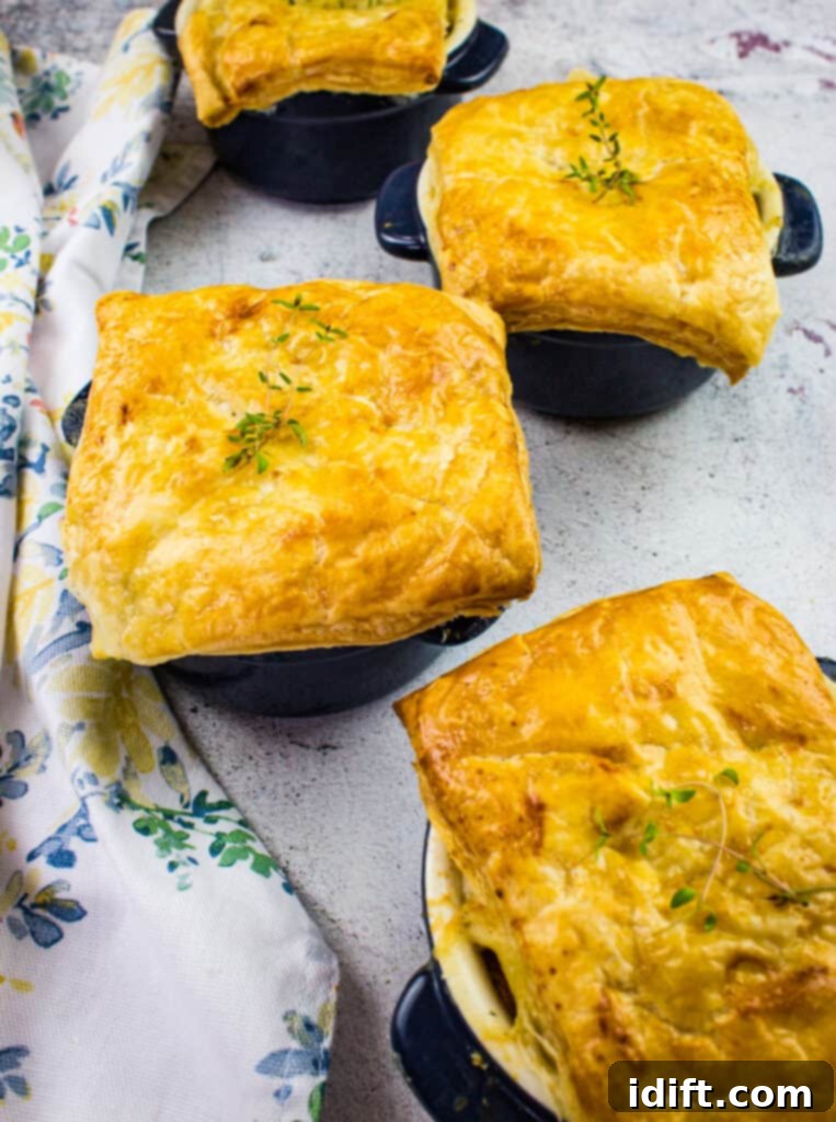 Delicious individual turkey pot pies with golden puff pastry topping, ready to serve.