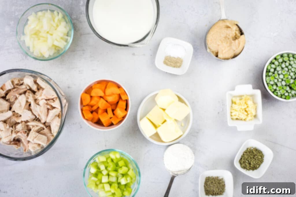 Prepped and diced ingredients, including carrots, celery, onion, and garlic, ready for cooking.