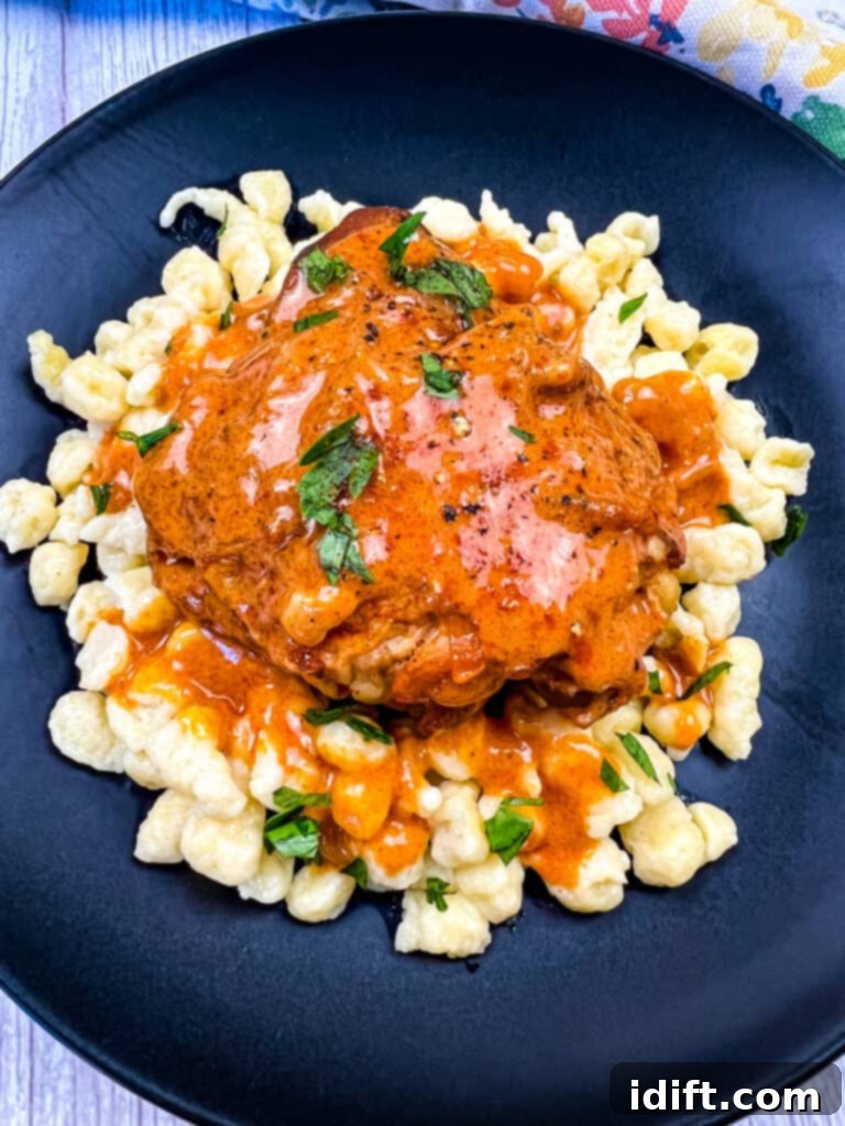 Instant Pot Chicken Paprikash served on a bed of spaetzle with a side of green beans