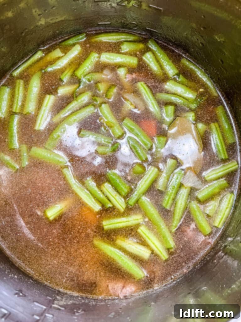 Hearty Instant Pot Steak and Potato Soup 7 adding remaining ingredients to make instant pot steak and potato soup recipe