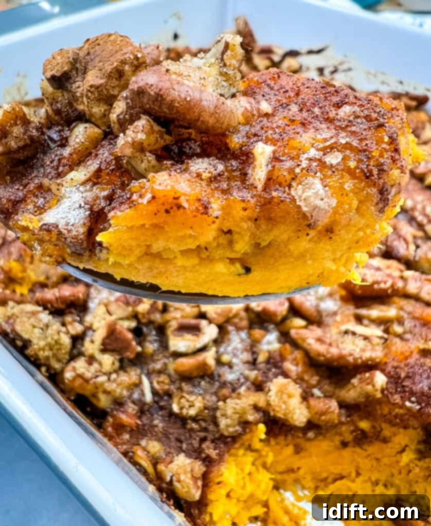 Maple Pecan Sweet Potato Bliss 3 sweet potato casserole on a spoon, showing creamy texture and pecan topping