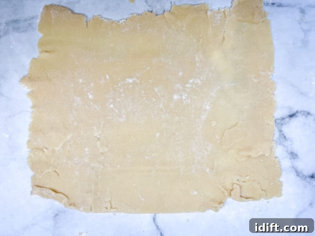 a rectangle of rolled cinnamon roll cookie dough