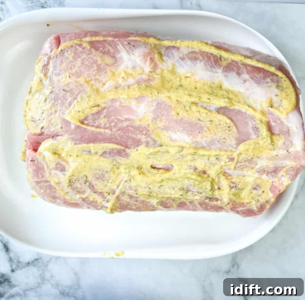 coating the pork with mustard
