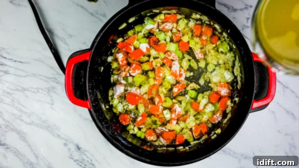 Sautéing veggies and adding wine and flour for chicken and cheddar dumplings