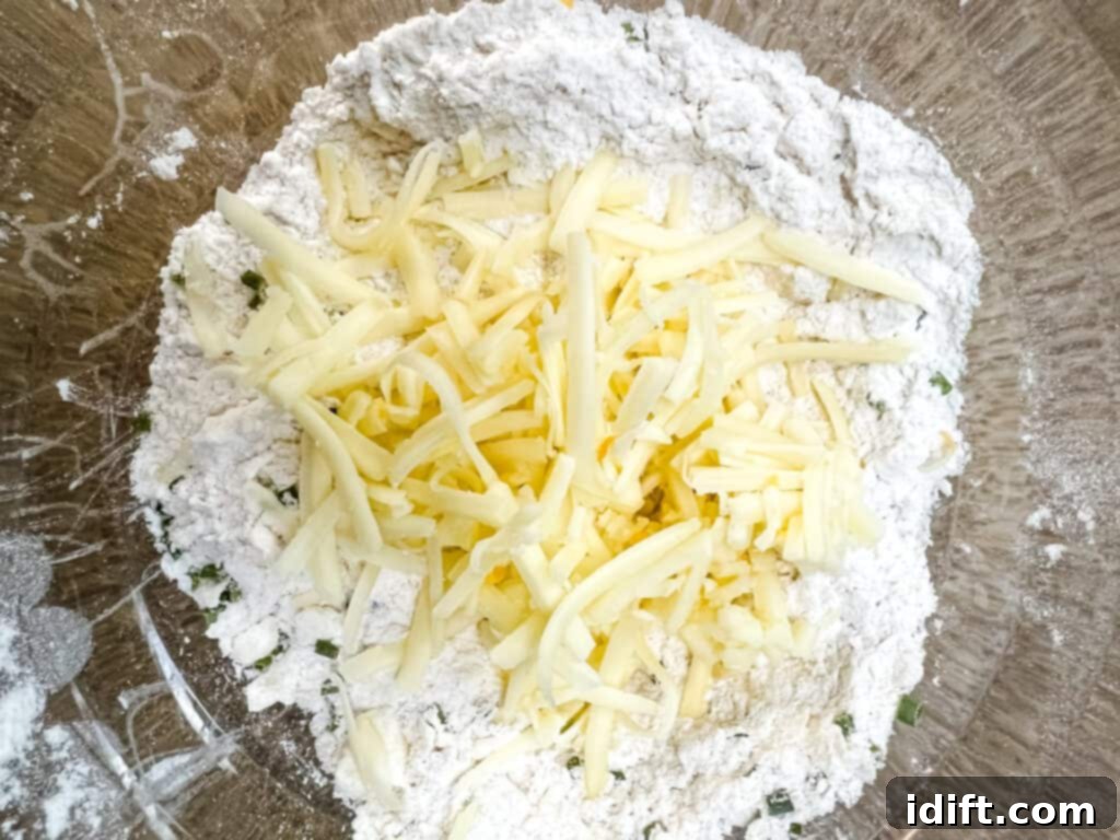 Adding cheese and chives to dumpling mixture