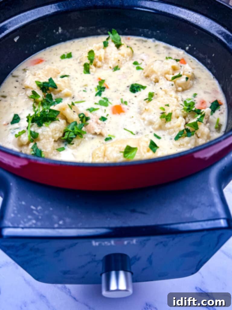 Chicken and cheddar dumplings cooking in an Instant Pot Dutch Oven