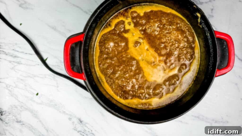 Whisking flour slurry into the braising liquid to thicken it into a rich, glossy gravy.