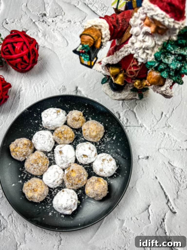 Decadent White Chocolate Bourbon Bites 2 bourbon balls with white chocolate on a black plate