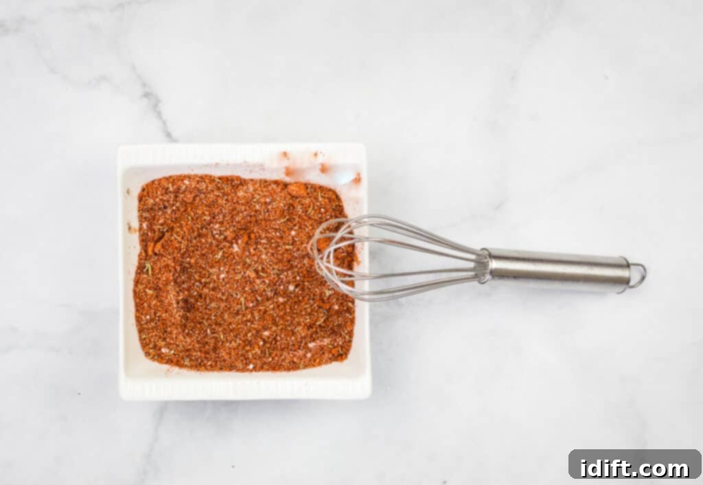 The best pork rub being mixed with a whisk in a bowl