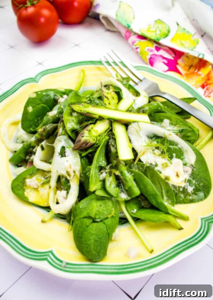 Spinach, asparagus, & fennel salad on a yellow plate