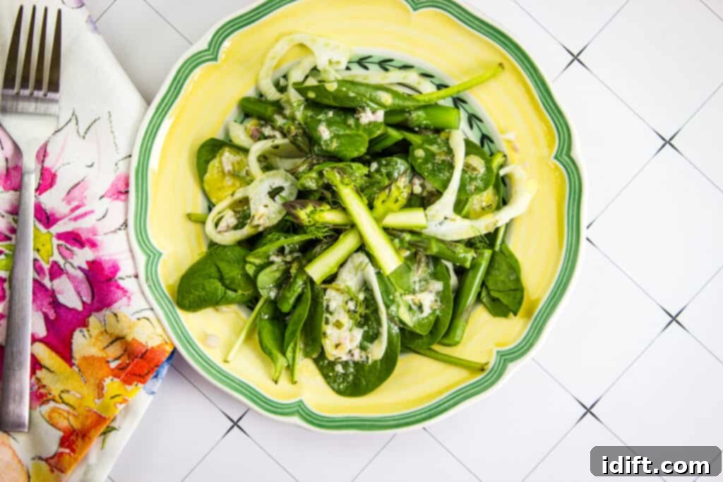 spinach, asparagus, & fennel salad on a yellow plate