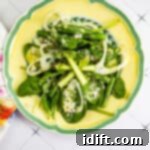 spinach, asparagus, & fennel salad on a yellow plate