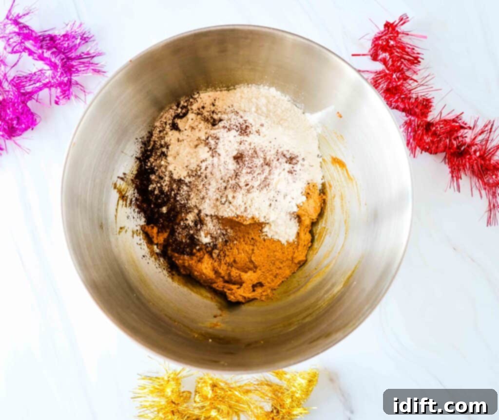 Mixing wet and dry ingredients in a bowl to form the chocolate gingerbread dough.