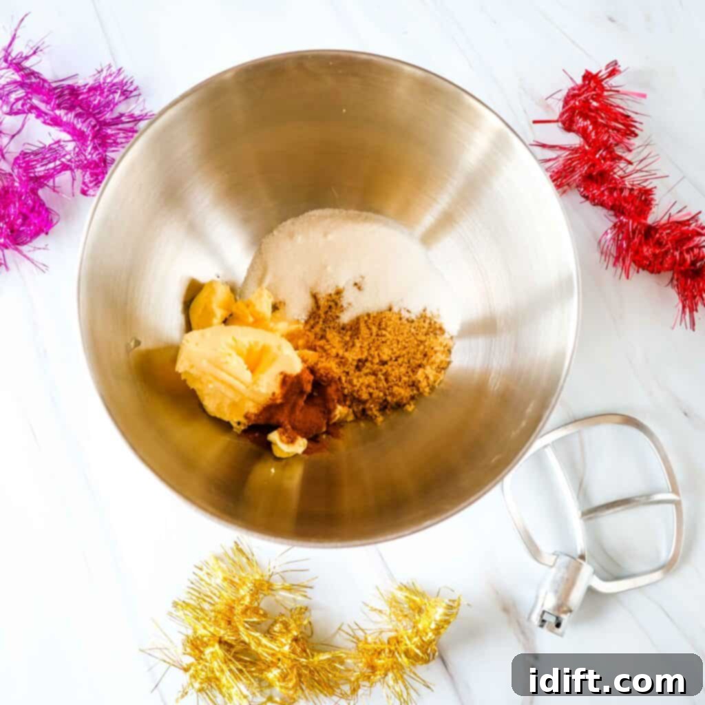 Creaming butter and sugar in a stand mixer bowl for chocolate gingerbread men cookies.