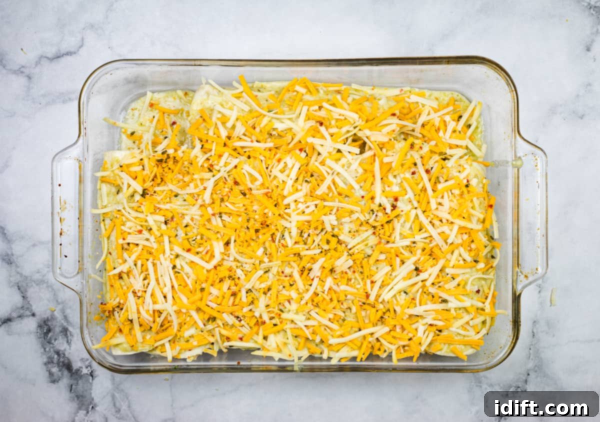 The casserole dish topped with cheese.